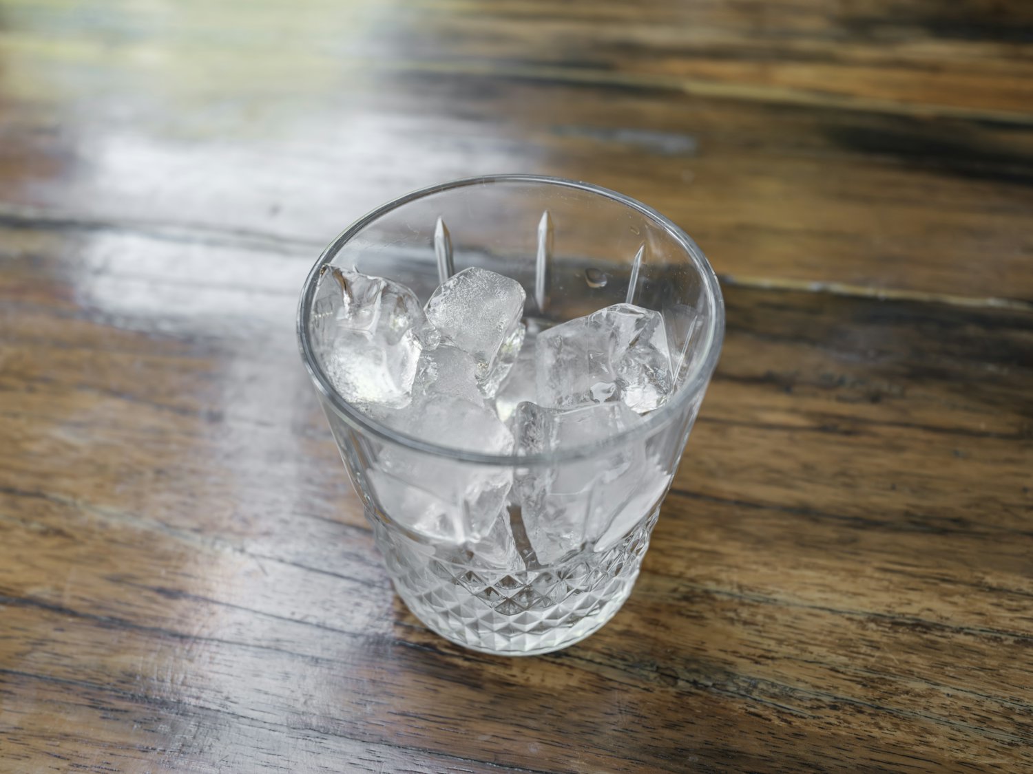 Clear glass filled with ice cubes
